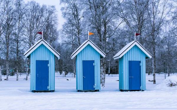 blue cabanas on the beach for changing clothes, winter beach in Oulu, Finland