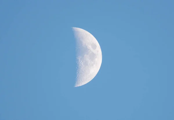 The moon is in the sky with a clear blue sky