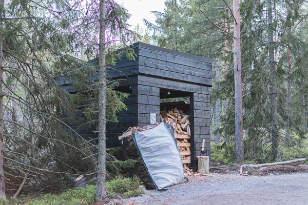 harvested firewood for a picnic in the forest, tourism in Finland