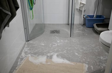 Excess water on the bathroom floor, flooding in the bathroom.  clipart