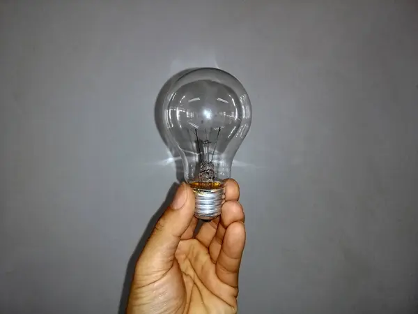 light bulb in hand, incandescent light bulb, incandescent lamp, incandescent light globe