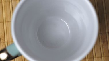 Koyu kahve granülleri beyaz bardağın dibine düşer. Sabahları kahve yapıyorum. Kahve yapma süreci. Yüksek kalite 4k görüntü