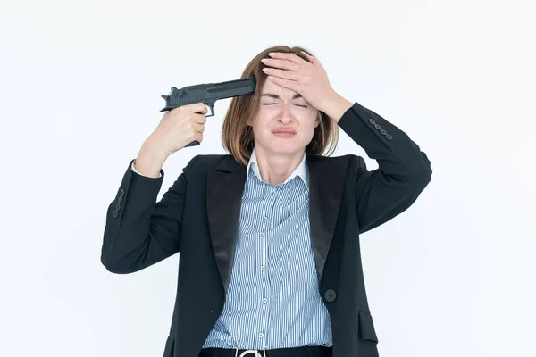 Young frustrated business woman with gun to head trying to commit a suicide because of bankruptcy