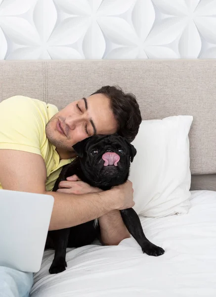 Smiling Happy Man Sitting Bed Hugging His Lovely Pet Black —  Fotos de Stock