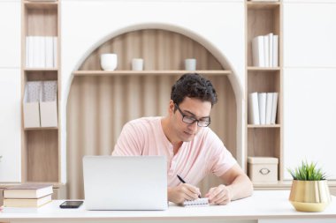 Young handsome man studying online at home. Distance education concept