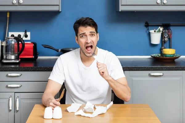 stock image Close up of unhappy man sitting at the table, stressed and confused by calculate expense from invoice or bills, have no money to pay mortgage or loan. High prices and spending money concept