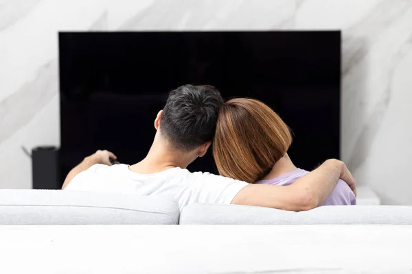 stock image Lovely couple watching tv together. Happy family leisure time concept