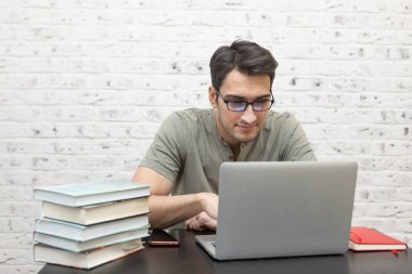 Young handsome man studying online at home. Distance education concept