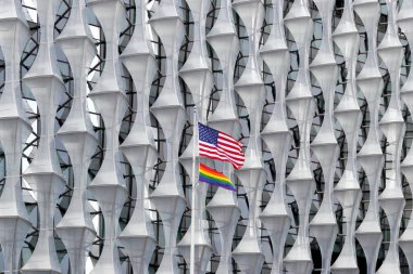 London, UK - Jun 19, 2022: American and rainbow flags waving at the Embassy of the United States of America in London, the diplomatic mission of the United States in the United Kingdom clipart
