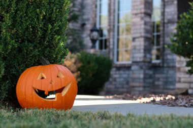 residential house entrance decorated with big halloween pumpkin . High quality photo clipart