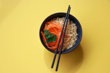 Sarı arka planda çubuk desenli vejetaryen ramen eriştesi. Yüksek kalite fotoğraf