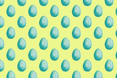 seamless pattern of hand painted colourful easter eggs on yellow background . High quality photo
