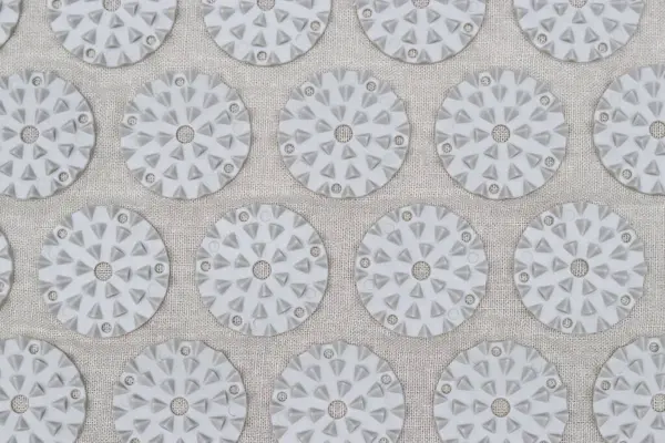 Close-up of orthopedic acupressure mat for self health massage in living room indoors. Alternative medicine relaxing treatment at home