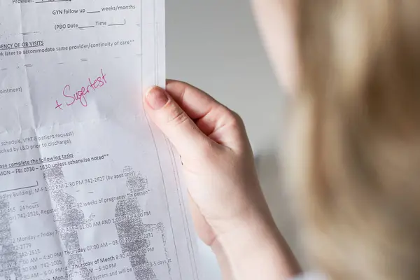 stock image Close up of a woman holding a pregnancy check-up application document for blood sugar test, maternity healthcare concept 