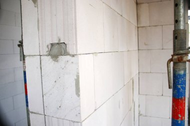 Beyaz taş duvarları beton ve destek kirişleri, çekirdek ve kabuk inşa konsepti olan yeni bir binanın içerisi.