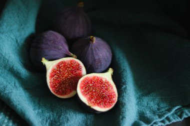 Taze incir meyvelerini koyu gölgeli yeşil kumaşla kaplayın..