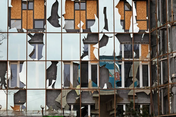 stock image Kharkiv, Ukraine - October 24, 2022: Broken windows of the glass facade of the building. Destruction due to the explosion of a Russian bomb during the attack on the city. Shattered glass