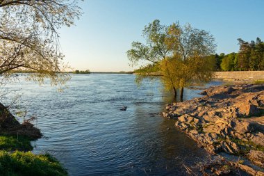 Dinyeper (Dnipro) nehrinin kıyısında, Ukrayna 'nın Kremenchuk şehrindeki toprak setinin yanındaki granit kaya.