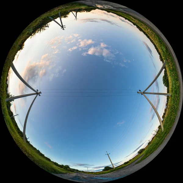 stock image Concrete poles with wires over the road in the countryside on a summer evening. Wide Angle Circular Fisheye Panorama. Spherical 180 degree Fulldome format