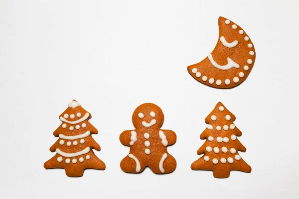 Christmas gingerbread cookies on a white background. Ready-to-eat homemade gingerbread cookies coated with sugar glaze. Free space for text
