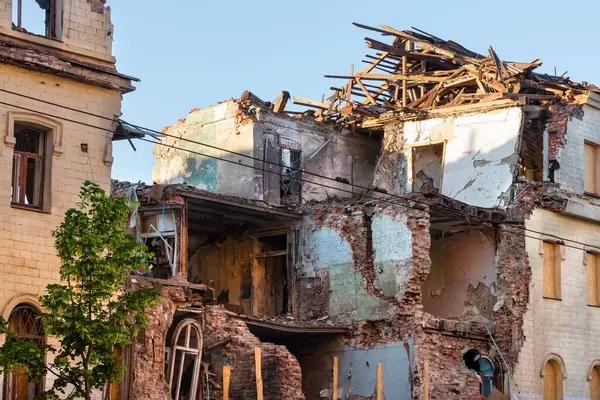 stock image Kharkiv city, Ukraine - may 2, 2023: The building was destroyed by a missile strike during the Russian army's bombing. An old brick house damaged by shelling, the result of Russian military aggression