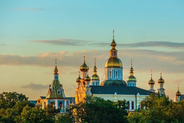 Kharkiv şehri, Ukrayna - 27 Haziran 2024: Ukrayna 'nın Kharkiv kentindeki Pokrovsky Manastırı' nda haçlı altın kubbeler. Güneşli bir yaz gününde Ortodoks Kilisesi