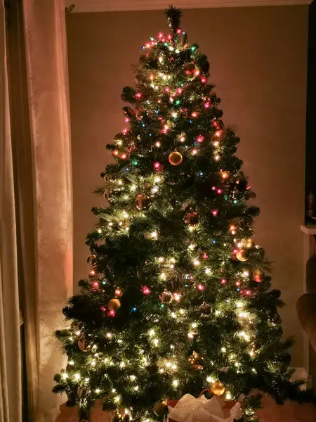decorated christmas tree with toys and lights.