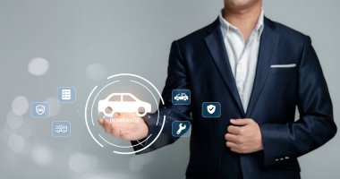 Takım elbiseli profesyonel bir adam araba sigortası konseptlerine dijital grafikler sunar. Görüntü, finans ve hizmet sektörlerindeki modern iş uygulamalarını gözler önüne seriyor.