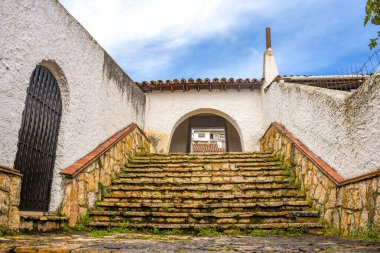 Guatavita, Cundinamarca 'da beyaz kemerler ve yemyeşil çimlerle çerçevelenmiş, Kolombiya' nın güzelliğini gözler önüne seren pitoresk bir taş yolu..