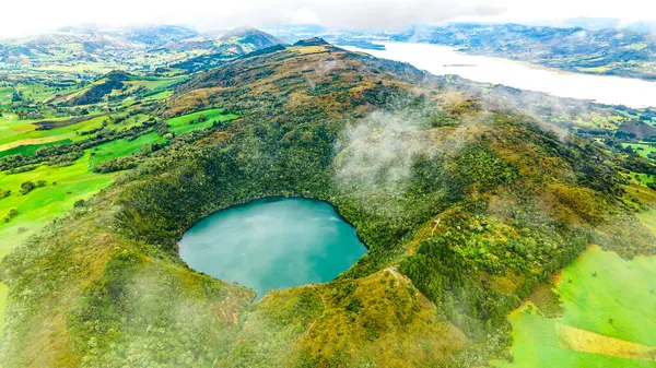 Kolombiya, Cundinamarca 'da yemyeşil yemyeşil ile çevrili el değmemiş Laguna de Guatavita' nın hava manzarası doğal güzelliğini ve kültürel önemini gözler önüne seriyor..