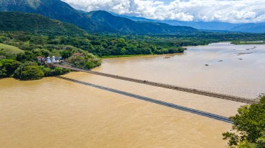 Santa Fe de Antioquia, Kolombiya 'da çevre nehir ve mimariyi gösteren bir köprünün manzaralı görüntüsü..