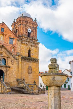 Mongui, Boyac, Kolombiya 'daki parlak gökyüzünün altındaki tarihi çeşme ve kilisenin güzel manzarası.