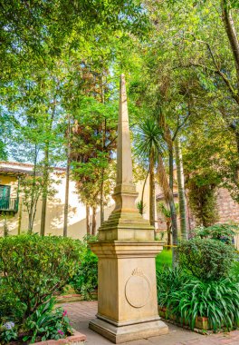 Bogot 'ta canlı bir plazada klasik mimari, mekandan hoşlanan insanlar ve belirgin bir şekilde Kolombiya bayrağı sergilendi..