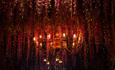 Canlı çiçeklerle süslenmiş güzel bir avize büyüleyici bir atmosfer yaratıyor..