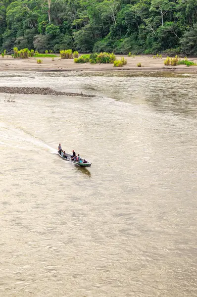 İnsanları taşıyan bir tekne Kolombiya 'daki Putumayo Nehri' nin sakin sularında dolanıyor..