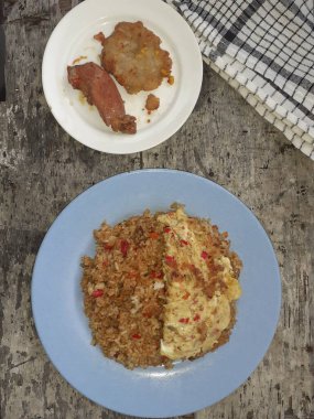 Özel kızartılmış pilav ve bir tabakta çırpılmış yumurta. Tadı çok güzel. Endonezya halkı için popüler bir yemek. Üst görünüm.