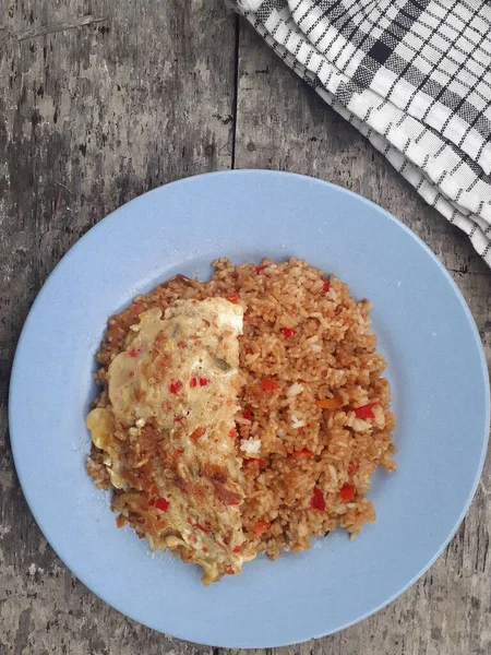 stock image Close up of special fried rice plus scrambled eggs on a plate. It tastes delicious. A popular dish for Indonesian people. Top view.