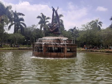 Jakarta,Indonesia,February 18,2023 : Monument statue of a primate in the middle of a roundabout fountain park in the Ragunan Wildlife Park area.