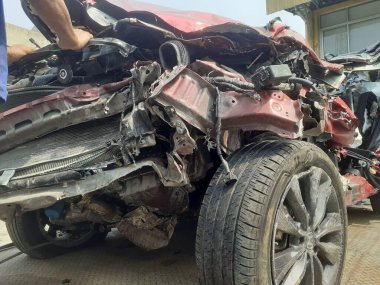 Cakarta, Endonezya, 11 Ekim 2023: Bir araba bir kaza sonucu çok kötü hasar gördü, çekiciden araba servisi atölyesine indirildiğinde görüldü.