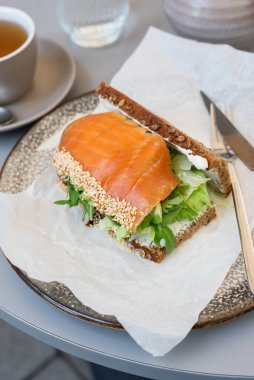 Toast with salmon and vegetables for breakfast. clipart