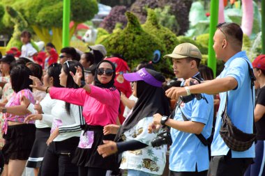 Malang, Indonesia - May 23, 2024 : A male photographer from Indonesia took part in group gymnastics activities at the 