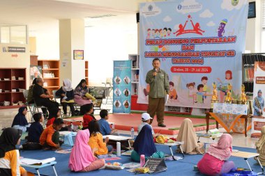 Tegal, Indonesia - July 28, 2024 : A boy is drawing in a drawing and coloring competition at the Brebes city library clipart