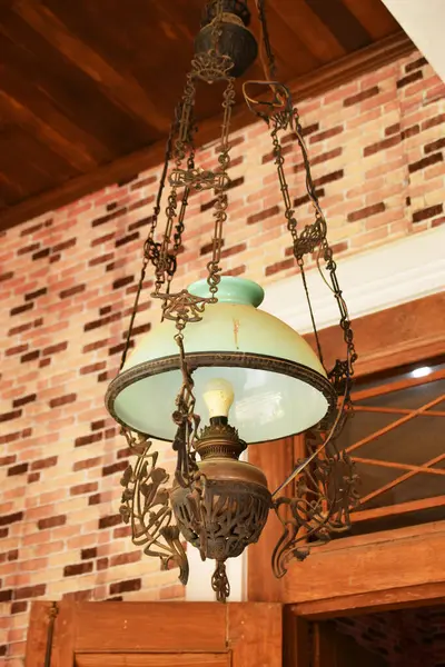 Yakın plan bir antika, Java süslemeli lamba, camsı bir gölgesi var..