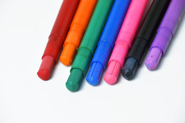 Multicolored silky crayons arranged neatly on a white background. Ideal for creative art, crafts, and education materials.