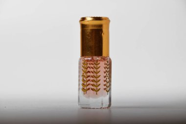 Küçük ve eşsiz bir plastik tutacağı olan, beyaz, izole bir arka planı olan hoş bir parfüm..