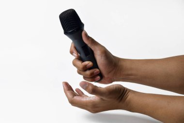 İzole edilmiş beyaz arka planı olan mikrofonu tutan bir adamın iki eli. Şarkı söylemek, konuşmak, ilahi söylemek, direniş ve demokrasi için uygun bir tema.