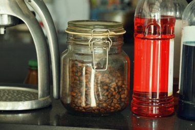 Endonezya 'da geleneksel bir kafede bir kavanoz kahve çekirdeği bir masada duruyor..