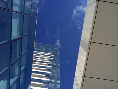 Tower and blue sky. Modern architecture in the city. Beautiful perspective.