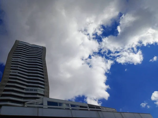 Modern architecture in the city. Clouds and beautiful blue sky.