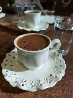cup of coffee with milk and chocolate on wooden background